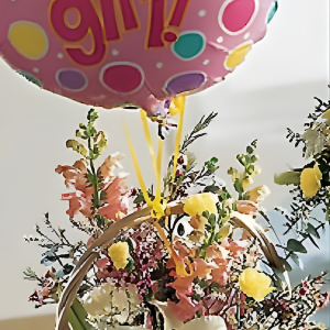 Basket with baby girl balloon
